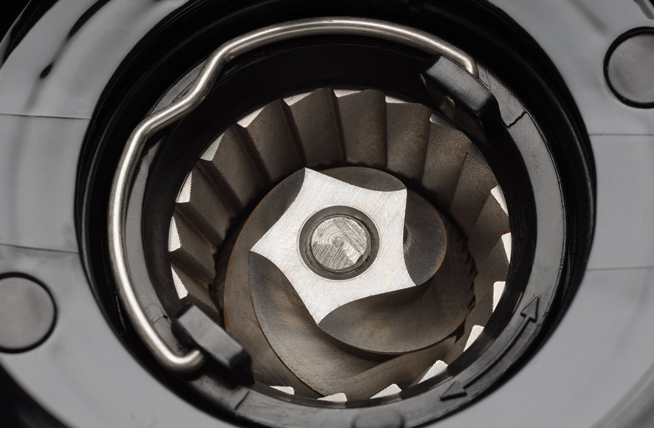 Conical burr set inside a coffee grinder grinding chamber, viewed from above