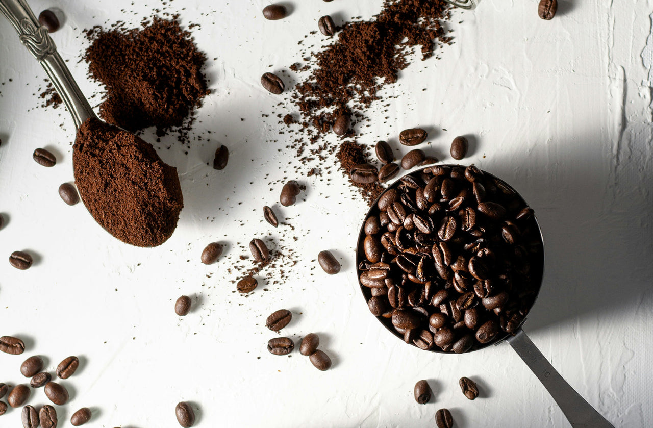 Ground espresso coffee and whole beans compared side by side