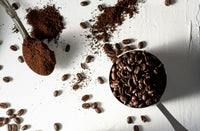 Ground espresso coffee and whole beans compared side by side