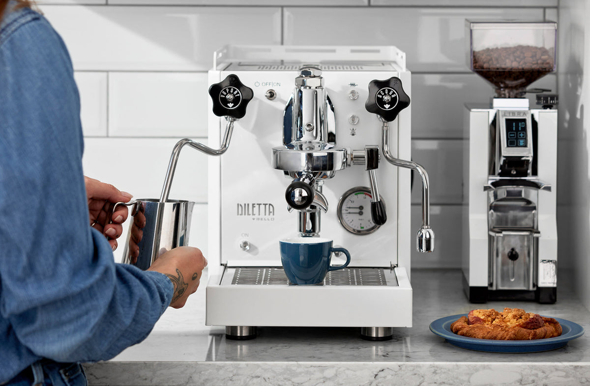 Diletta Bello espresso machine brewing a shot beside a Eureka Libra grinder