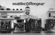 Seattle Coffee Gear crew member smiling behind four espresso machines in the studio