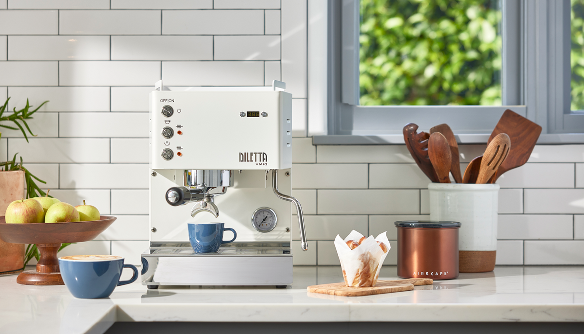 Diletta Mio sits on a kitchen counter with freshly made espresso and latte drinks. - Seattle Coffee Gear