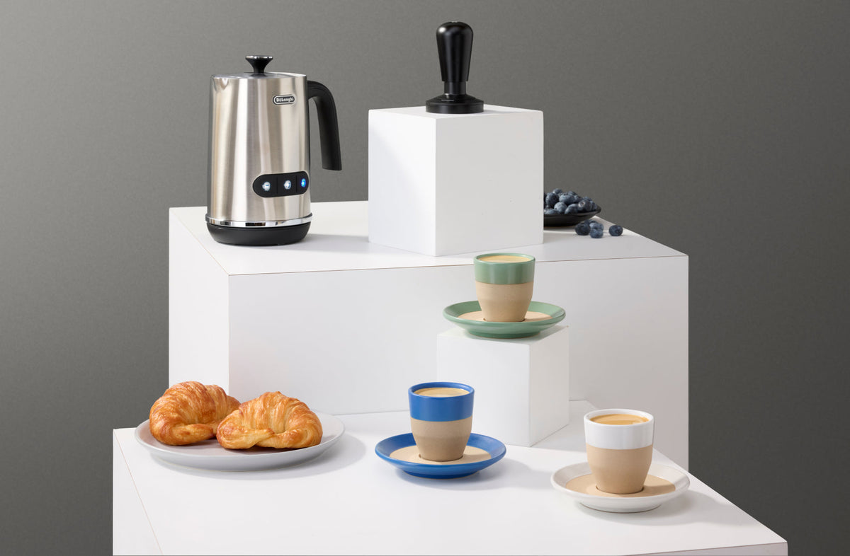 DeLonghi milk frother, espresso tamper, and notNeutral espresso cups on a coffee bar display