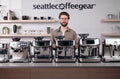 Six Breville espresso machines lined up on a Seattle Coffee Gear counter