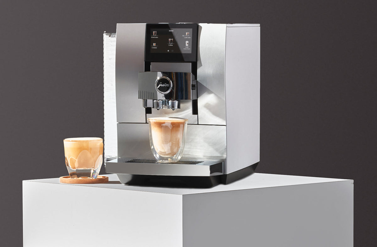 Jura Z10 superautomatic espresso machine brewing a latte macchiato on a countertop - Seattle Coffee Gear