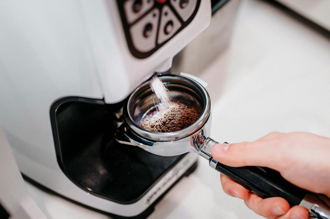 Coffee grinding into portafiliter - Photo by Charles Sims for Unsplash - Seattle Coffee Gear