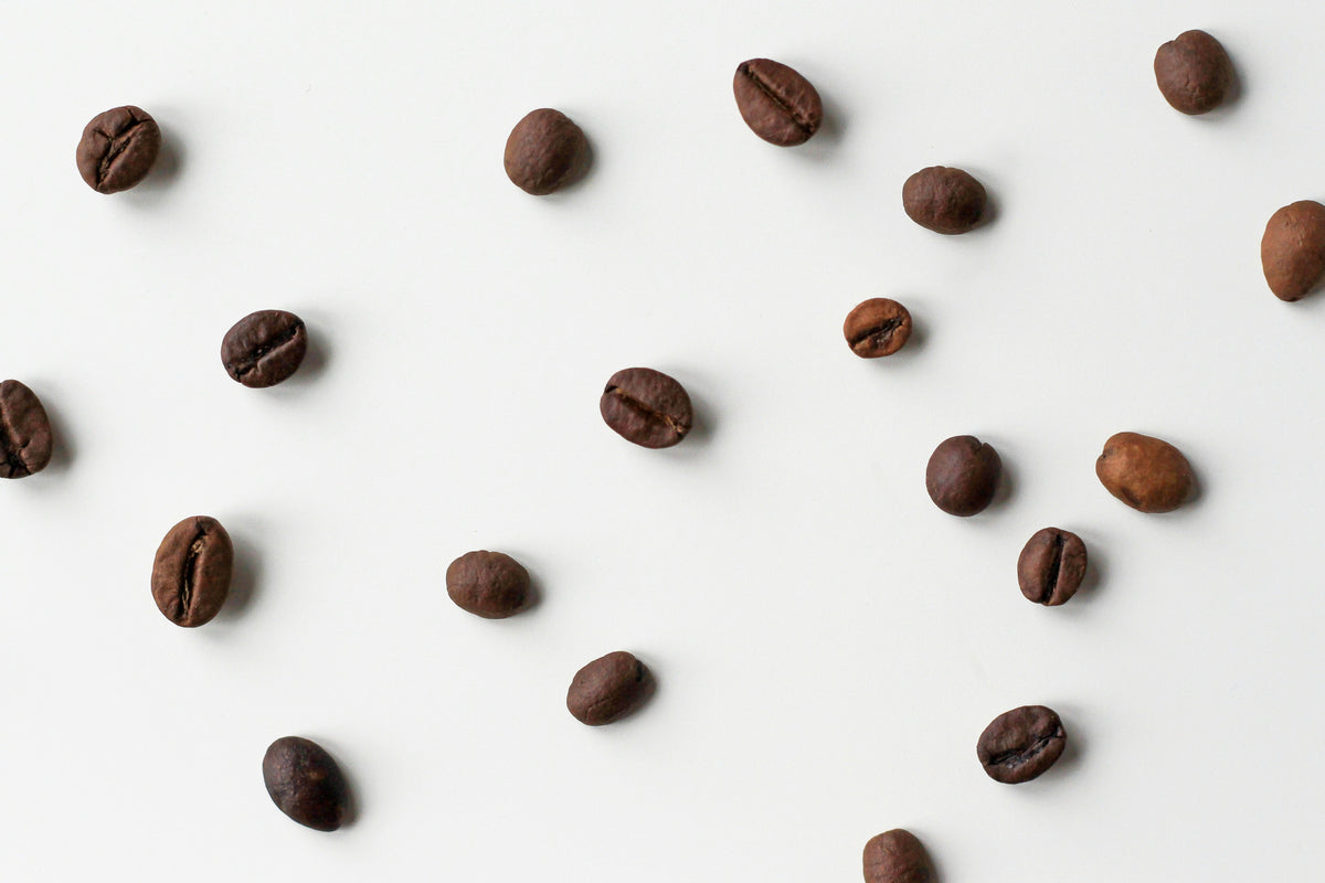 Coffee beans on a white backgroumd - by Nordwood Themes via Unsplash - Seattle Coffee Gear